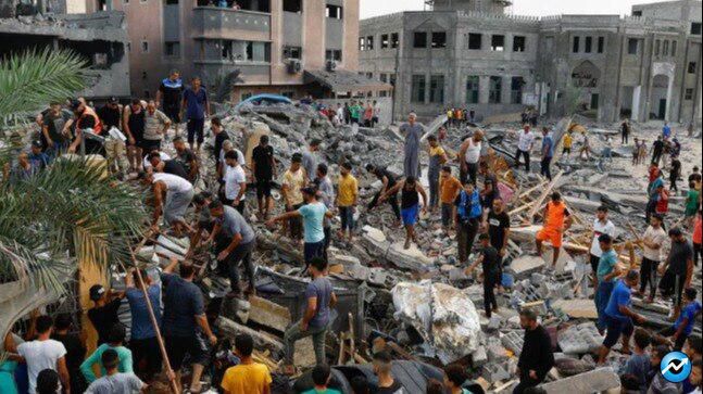 palestinians-walk-among-the-rubble-of-a-building-destroyed-in-israeli-strikes--in-the-southern-gaza-14333669-16x9